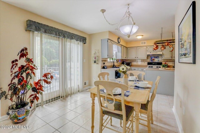 tiled dining space featuring sink