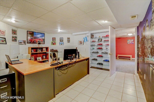 carpeted office featuring a paneled ceiling