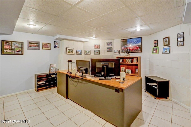 office featuring light tile patterned floors and a paneled ceiling