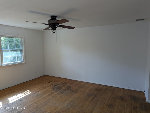 unfurnished room featuring hardwood / wood-style floors and ceiling fan