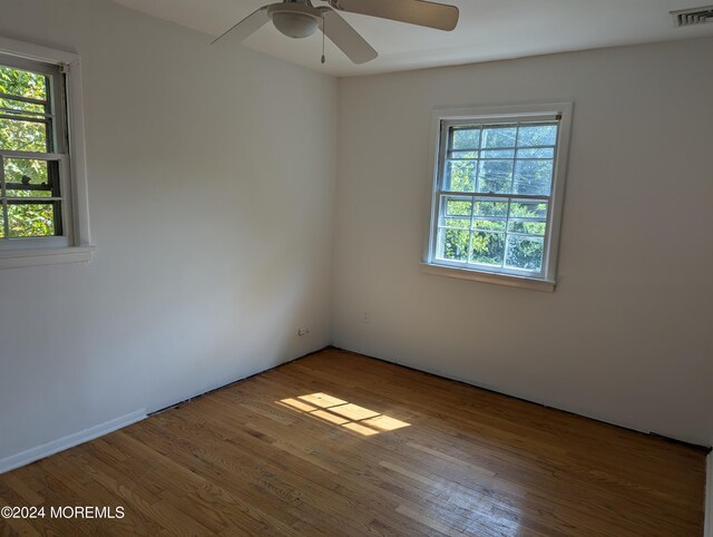 unfurnished room featuring hardwood / wood-style floors and ceiling fan