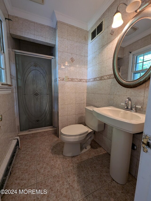 bathroom featuring tasteful backsplash, tile patterned flooring, crown molding, toilet, and tile walls