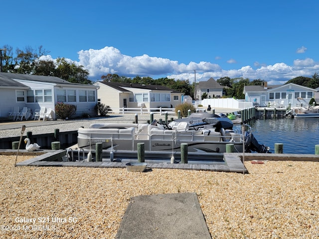 exterior space featuring a boat dock and a water view