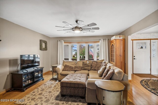 living room featuring light wood-type flooring and ceiling fan