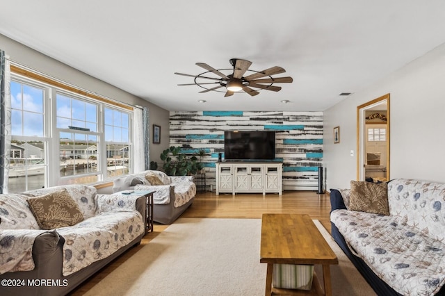 living room with wood-type flooring and ceiling fan