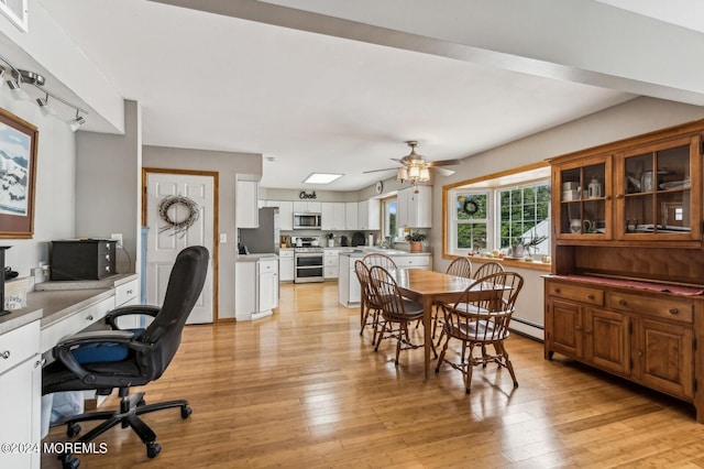 dining area featuring a baseboard radiator, light wood-type flooring, and ceiling fan