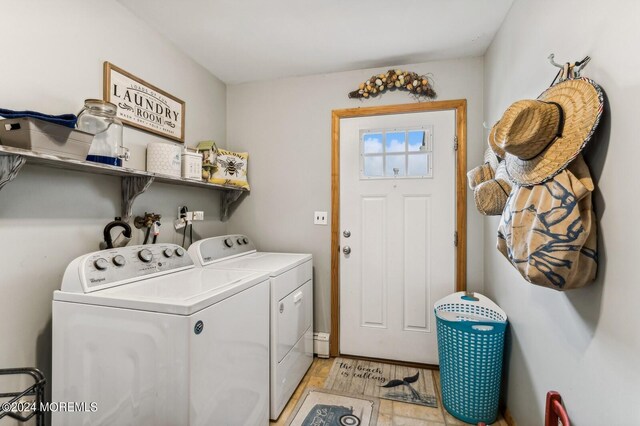 laundry area featuring light hardwood / wood-style flooring and washing machine and dryer