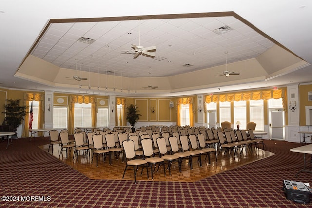 interior space with a tray ceiling and ceiling fan