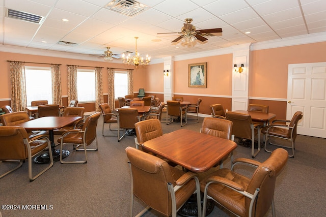 dining room featuring ceiling fan with notable chandelier, ornamental molding, and carpet floors