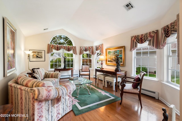 living room featuring hardwood / wood-style flooring, a baseboard radiator, and lofted ceiling