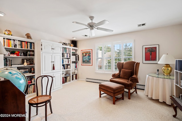 carpeted office featuring ceiling fan and a baseboard heating unit