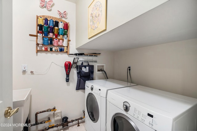 laundry area with cabinets, separate washer and dryer, and sink