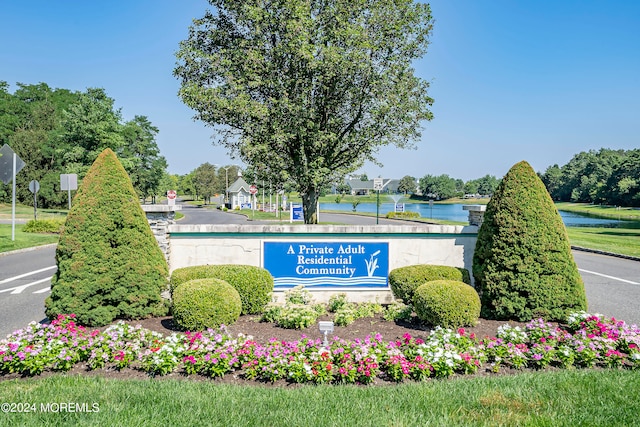 community sign featuring a water view