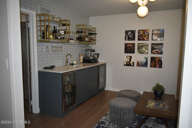 bar with dark hardwood / wood-style floors, wine cooler, sink, and tasteful backsplash