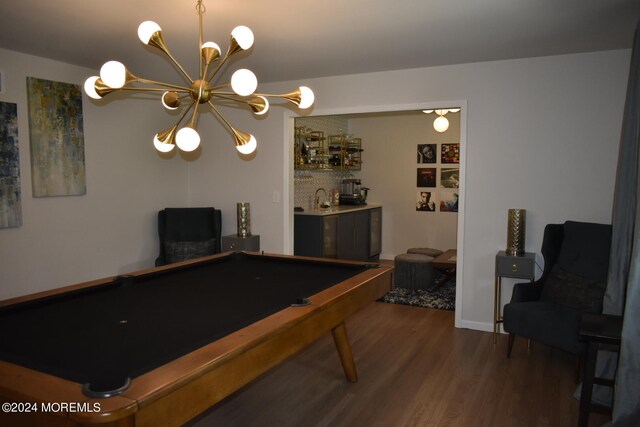 rec room featuring sink, billiards, a chandelier, and dark wood-type flooring