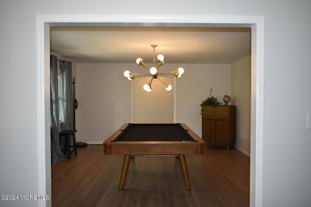 dining room featuring a notable chandelier, dark hardwood / wood-style floors, and pool table