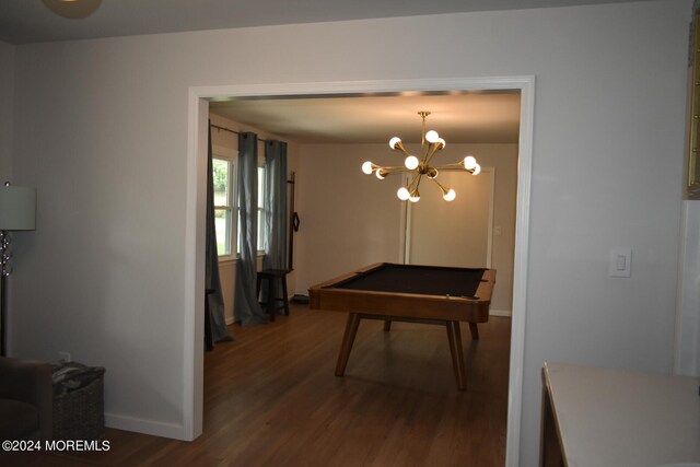 dining space featuring wood-type flooring, pool table, and a chandelier