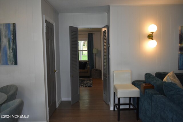 interior space with dark hardwood / wood-style floors and crown molding