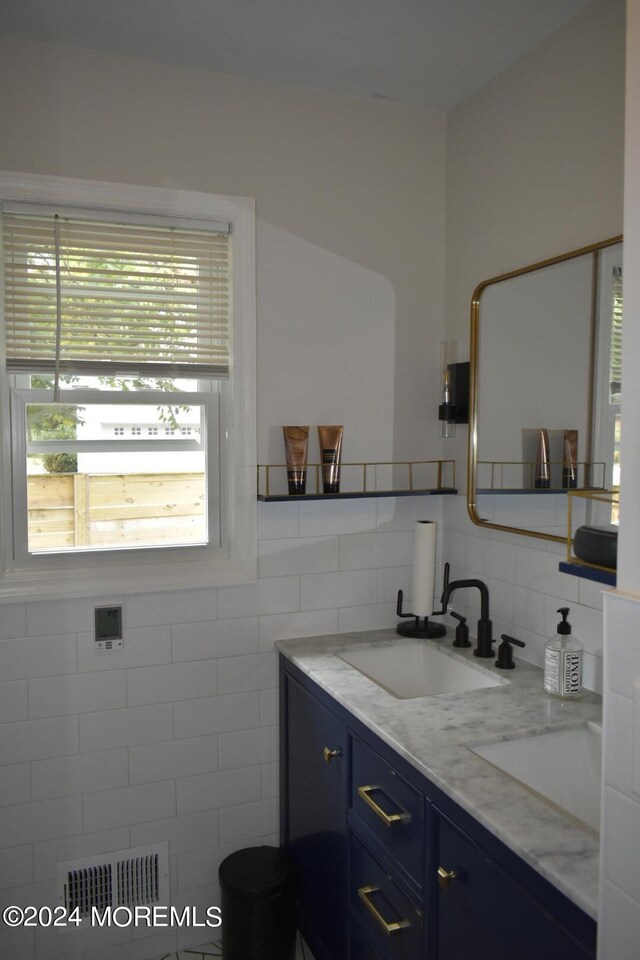 bathroom featuring tile walls and vanity