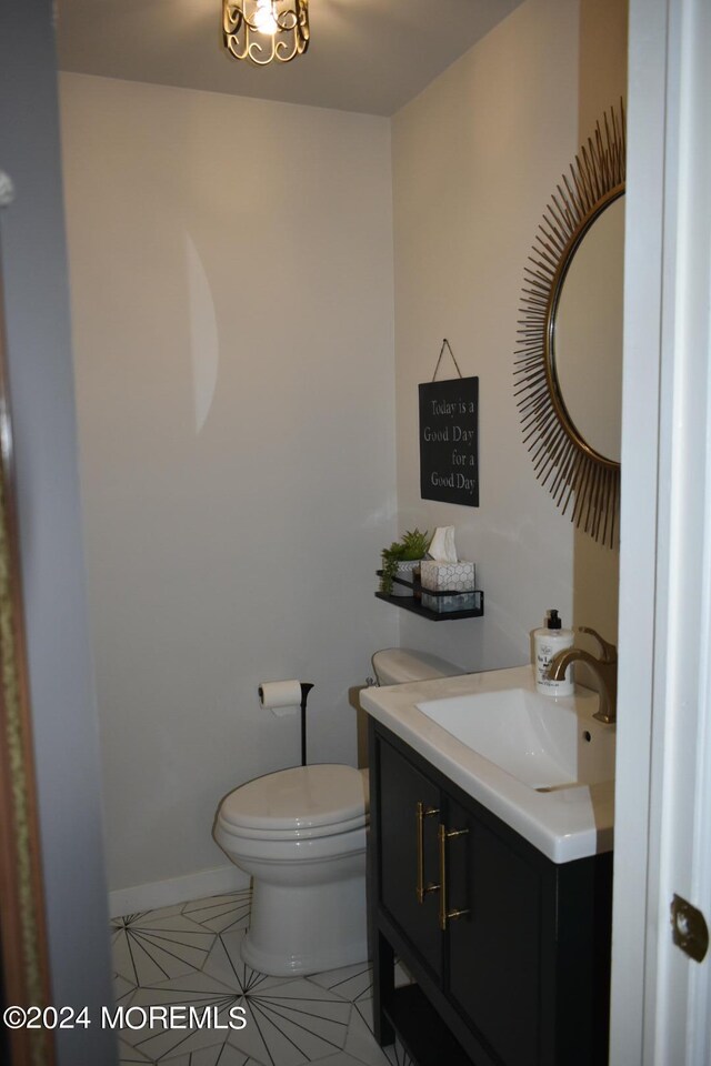 bathroom featuring vanity, toilet, and tile patterned floors