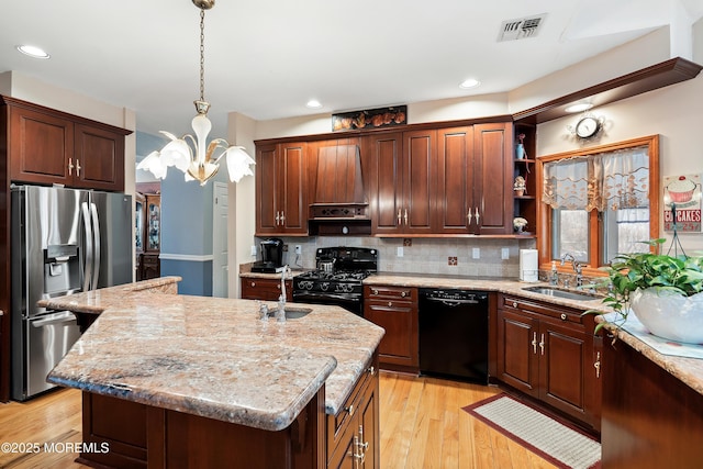 kitchen with visible vents, a sink, black appliances, open shelves, and backsplash