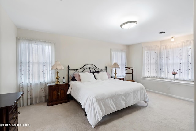 bedroom featuring light carpet, baseboards, and visible vents