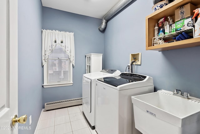 laundry area featuring light tile patterned floors, a baseboard heating unit, laundry area, a sink, and independent washer and dryer