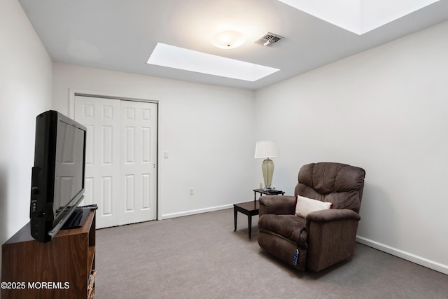 living area with carpet floors, a skylight, baseboards, and visible vents