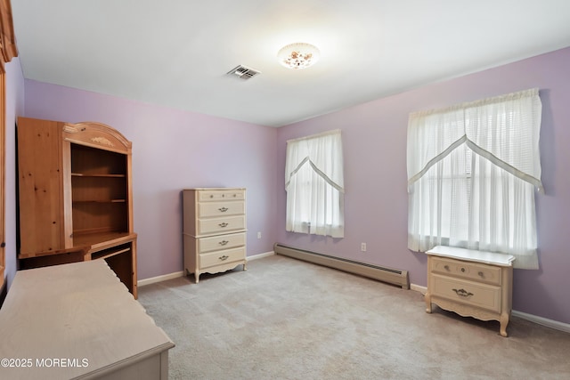 office featuring a baseboard heating unit, light colored carpet, visible vents, and baseboards