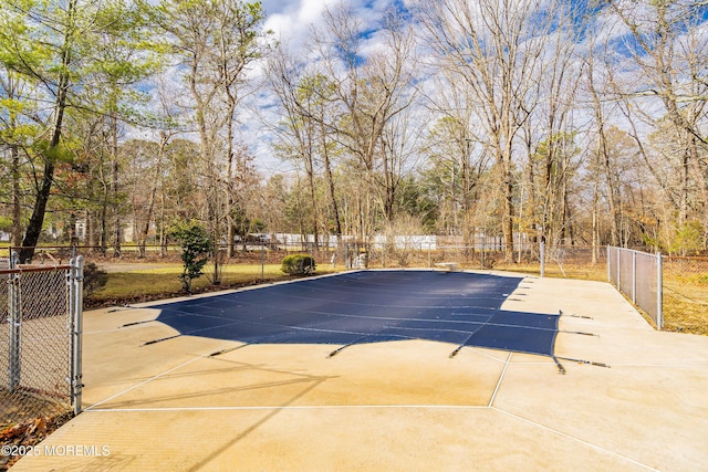 view of swimming pool featuring fence