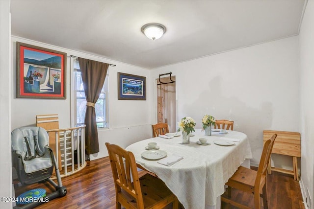 dining space featuring dark wood-type flooring