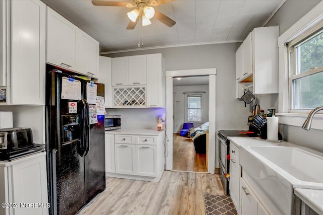 kitchen with light hardwood / wood-style floors, sink, white cabinetry, stainless steel appliances, and ornamental molding