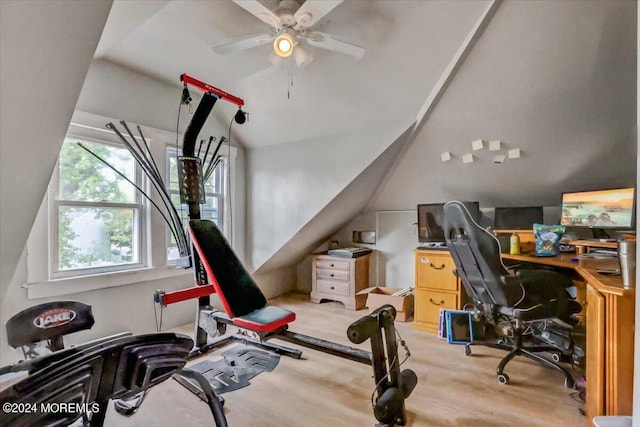 exercise room featuring light wood-type flooring, vaulted ceiling, and ceiling fan