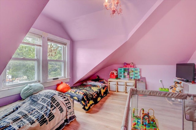 bedroom featuring light hardwood / wood-style flooring and lofted ceiling