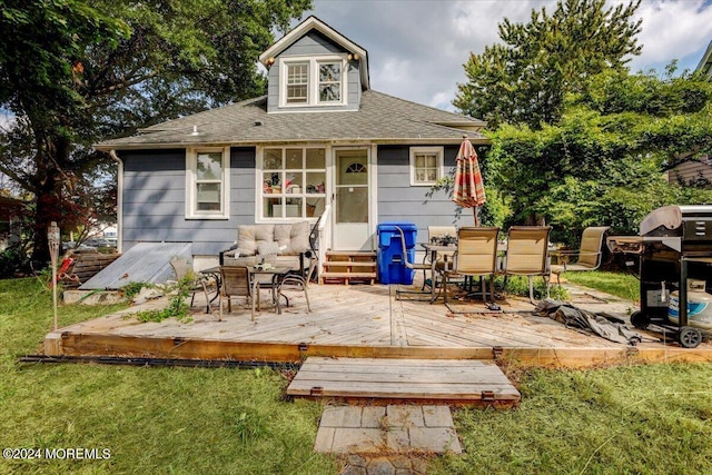 back of house featuring a deck and a yard