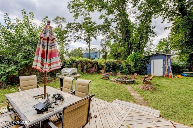 wooden deck with a storage shed and a yard