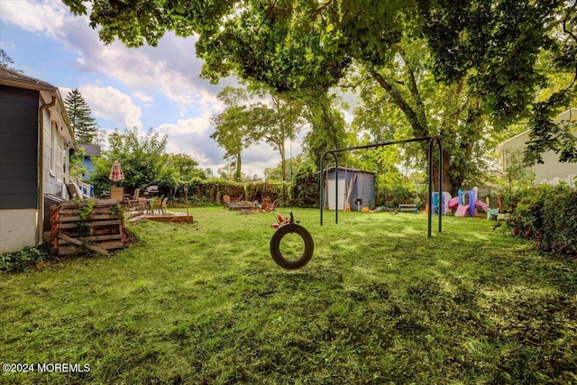 view of yard with a playground and a storage unit