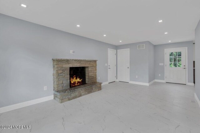 unfurnished living room featuring a fireplace