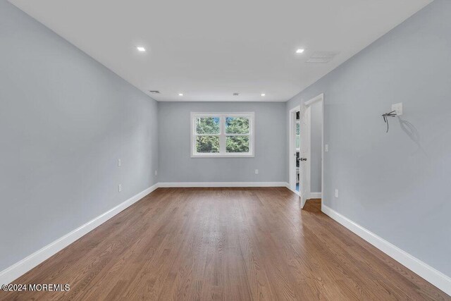 unfurnished room featuring hardwood / wood-style floors