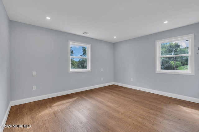 empty room with light hardwood / wood-style flooring