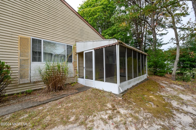 view of property exterior featuring a sunroom