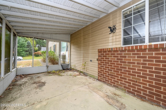 unfurnished sunroom with vaulted ceiling