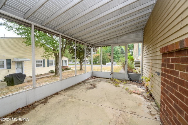 unfurnished sunroom with lofted ceiling