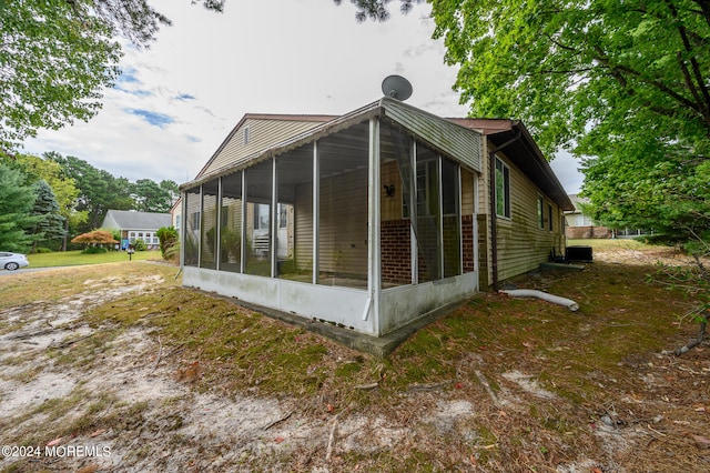 view of side of property with a sunroom