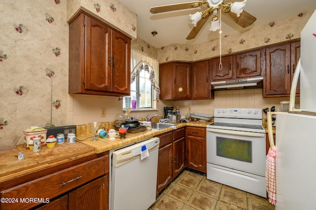 kitchen with white appliances, ceiling fan, tasteful backsplash, and sink