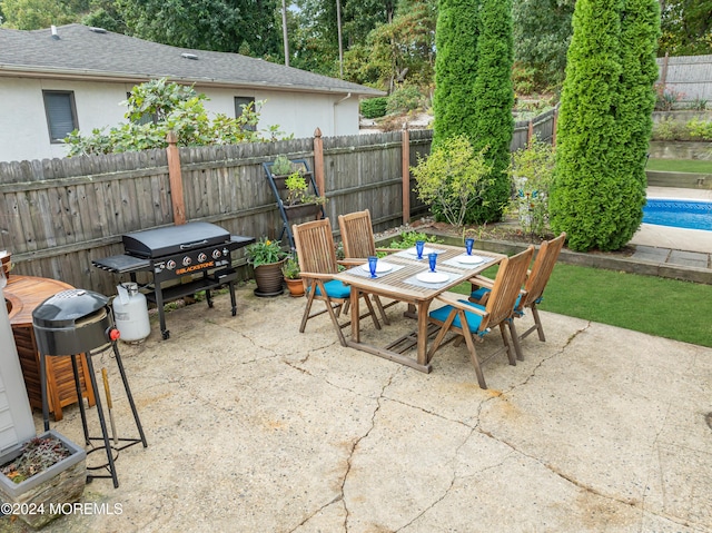 view of patio / terrace featuring outdoor dining area, a fenced backyard, and a grill