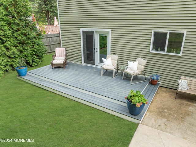 deck with a lawn and fence