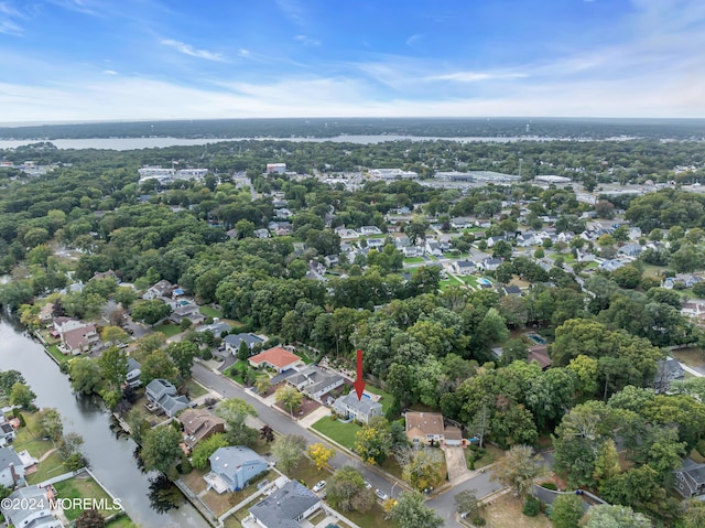 bird's eye view featuring a water view and a residential view