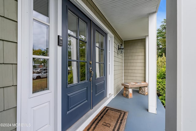 view of exterior entry featuring a porch