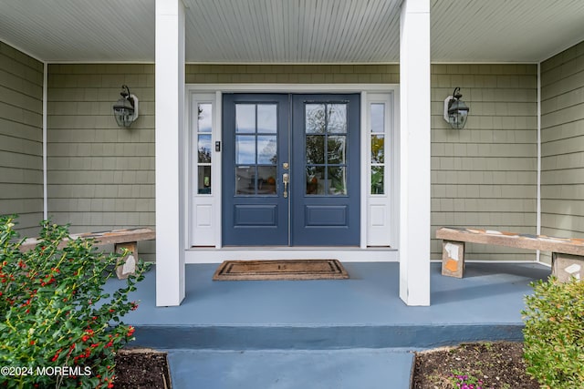 property entrance with a porch and french doors